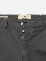 Close-up of the waist and button fly of BGpaulo Pavia 1 V2 Chino pants in charcoal, crafted from cotton stretch fabric with brown stitching. A label inside features the Blue de Gênes brand, “Made in Italy,” and a small Italian flag.