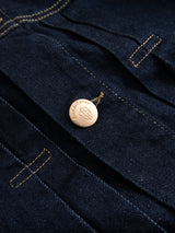 Close-up of dark blue denim with yellow stitching and a Blue de Gênes button, showcasing the BGcosimo Trucker V2 Jacket—a classic western style made in Italy.