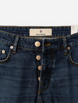 Close-up of BGvinci Arrow Jeans in Denim Blue by Blue de Gênes, featuring exposed copper buttons, yellow stitching, and a branded label sewn inside the waistband, highlighting the comfort stretch denim.