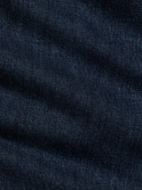 Close-up of denim blue BGvinci Arrow Jeans by Blue de Gênes, highlighting the textured weave pattern and subtle color variations in the fabric. The comfort stretch denim offers a regular fit that moves with you throughout the day.