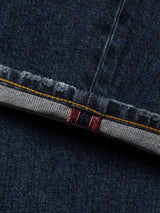 Close-up of the cuff of Blue de Gênes BGvinci Arrow Jeans in Denim Blue, regular fit, highlighting the inside seam with distinctive white and red stitching and yellow stitching along the hem. Crafted from comfort stretch denim for ease of movement and lasting style.