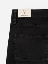 Close-up of the BGvinci TrueBlack Jeans by Blue de Gênes, crafted from black comfort stretch denim. A rectangular Blue de Gênes tag is attached to the waistband, while visible back pocket and stitching details showcase the regular fit jeans' expert craftsmanship.