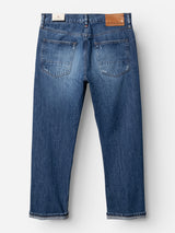 Back view of the BGmarco Sioux Jeans - Used by Blue de Gênes, crafted from cotton denim and featuring two rear pockets, a brown leather patch on the waistband, and cuffed bottoms for a classic relaxed fit.