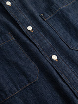 Close-up of the BGgregor Denim Shirt - Denim Blue by Blue de Gênes, featuring white buttons, brown stitching, and two chest pockets.