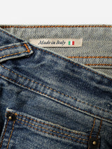 Close-up of BGgiacomo Alfie Jeans - Mid Blue Denim by Blue de Gênes in comfort stretch denim, featuring a tag that reads Made in Italy with a small Italian flag beside it. These relaxed loose fit jeans showcase visible stitching and metal rivets.