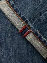Close-up of BGgiacomo Alfie Jeans - Mid Blue Denim by Blue de Gênes, featuring a folded cuff with visible orange stitching and a red selvedge edge, crafted from comfort stretch denim for an easy, relaxed loose fit.