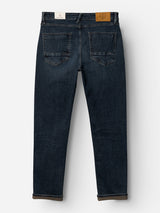 Introducing the BGvinci Ewan Jeans - Color Denim by Blue de Gênes: a pair of regular fit jeans in a dark blue wash, pictured from the back and featuring two back pockets, a brown leather patch on the waistband, and straight-cut legs crafted from comfortable stretch denim.