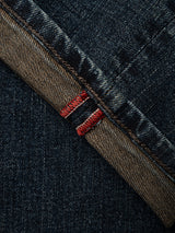 Close-up of the inside seam of the Blue de Gênes BGvinci Ewan Jeans in Color Denim, featuring distinctive red and white selvedge stitching along the edge. Crafted from comfort stretch denim, these regular fit jeans combine classic style with ease of movement.