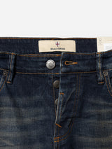 Close-up of the BGvinci Finlay Jeans - Vintage Wash by Blue de Gênes, featuring blue comfort stretch denim in a regular fit. Details include the waistband, two buttons, buttonhole, belt loops, front pocket edges with tan stitching, and a beige label bearing the Blue de Gênes logo on the inside—crafted for everyday wearability.