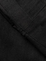 Close-up of black denim fabric from the BGpalco Ian Pant by Blue de Gênes, highlighting seam and stitching details reminiscent of the refined finish found in relaxed fit trousers.