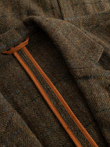 Close-up of the BGleopardi Skotch Blazer - Brown Check by Blue de Gênes, featuring a brown herringbone wool fabric with a subtle check pattern, detailed with a classic lapel, horn buttons, and an inner seam trimmed with tan leather.