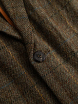 Close-up of the BGleopardi Skotch Blazer - Brown Check by Blue de Gênes, showcasing its textured brown wool check fabric with thin yellow and blue plaid lines and a prominent black horn button.