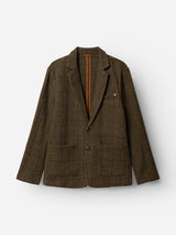 The BGleopardi Skotch Blazer - Brown Check by Blue de Gênes is a brown wool blazer with a textured check pattern, two horn buttons, large front pockets, and a notched collar. Displayed against a plain white background, the blazer also features a small orange detail inside the collar.