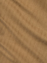 Close-up of tan herringbone fabric with diagonal, textured zigzag pattern and subtle shadows, highlighting the fine woven detail and a soft, slightly wrinkled appearance—ideal for the BGmenzo Rory Chino - Khaki by Blue de Gênes, whether worn as classic chinos or paired with a matching blazer.