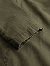 Close-up of the BGgabbiano Rory Blazer - Army by Blue de Gênes, focusing on the olive green sleeve with its subtle washed herringbone fabric and a visible seam at the cuff, emphasizing the blazer’s unconstructed design.