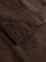 Close-up of the BGvalan Suede Jacket in Dark Brown by Blue de Gênes, highlighting the neatly stitched seam and textured, soft suede surface—perfect details that define this refined jacket-blazer hybrid.