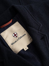 A close-up of the BGlewis Wool Blazer in dark navy, featuring a beige Blue de Gênes label with a shield logo stitched inside, highlighting the brand’s relaxed tailoring.