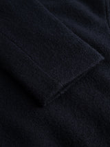 A close-up of the dark, textured fabric of the Blue de Gênes BGlewis Wool Blazer in Dark Navy, highlighting the sleeve and seam details of this double-breasted jacket.