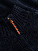 Close-up of the BGfraser Zip Knit in Dark Navy by Blue de Gênes, featuring a ribbed wool texture and a brown leather zipper pull, partially unzipped at the collar to showcase the classic half-zip design.