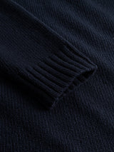 A close-up of the BGgordon Knit - Dark Navy by Blue de Gênes, highlighting the ribbed cuff and textured wool fabric.