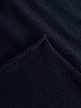 Close-up of the BGgordon Knit - Dark Navy by Blue de Gênes, featuring a folded edge that highlights the texture and fine stitching details of this wool crew neck sweater.
