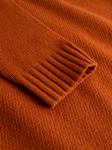 Close-up of the sleeve and body of the BGgordon Knit - Ginger Bread Orange wool sweater by Blue de Gênes, highlighting the detailed ribbed cuff and textured fabric.
