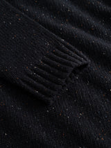 Close-up of the BGadamo Crewneck Knit - Dark Navy by Blue de Gênes, highlighting the sleeve in black wool with subtle white and brown multicoloured nep specks throughout, showcasing the detailed texture of the fabric.