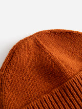 Close-up of the BGboshi Beanie in Ginger Bread Orange by Blue de Gênes, showcasing detailed knitted stitching and a ribbed turn-up edge, set against a plain white background.