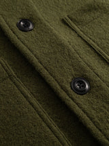 Close-up of the BGhew Wool Overshirt – Winter Moss by Blue de Gênes, highlighting its two black buttons, textured olive green boiled wool fabric, and precise stitching details.