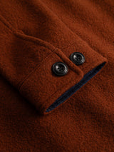 Close-up of the BGhew Wool Overshirt - Ginger Bread Orange by Blue de Gênes, highlighting the brown wool sleeve with two black buttons and a dark inner lining—details that evoke the sturdy craftsmanship of classic workwear overshirts.