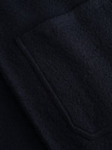A close-up of the BGmudock Wool Waistcoat by Blue de Gênes in Dark Navy highlights its richly textured wool fabric and visible pocket seam, showcasing fine fibers and soft material reminiscent of classic workwear.