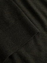 Close-up of the BGhamish Crewneck Knit in Beech Green by Blue de Gênes, crafted from dark green merino wool with a ribbed cuff seam and smooth texture.