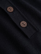 Close-up of the BGigor Polo Knit in Dark Navy by Blue de Gênes, showcasing its fine-gauge knit fabric and two brown, round, textured buttons sewn onto the placket—highlighting the refined details of this men’s long-sleeve polo.