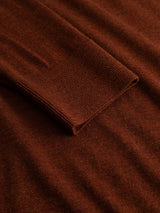 A close-up of the Blue de Gênes BGigor Polo Knit in Ginger Bread Orange, focusing on the sleeve and part of the body to highlight the ribbed cuff texture and soft fine-gauge knit fabric.