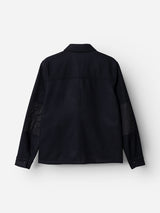 The BGBoyd Wool Jacket - Dark Navy by Blue de Gênes, shown from the back, is a long-sleeve utility jacket crafted in dark navy wool. This piece features a collar, visible seams, and buttoned cuffs. Subtle darker patches on the elbows enhance its durable workwear appeal.