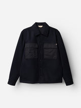 The BGBoyd Wool Jacket in Dark Navy by Blue de Gênes is a button-up shirt jacket with a collar and two large front chest pockets, featuring waxed cotton details for added durability, displayed on a plain white background.