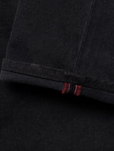 Close-up of the hem of Blue de Gênes BGvinci Iro Pant in navy, highlighting the visible red and white stitched selvedge edge and showcasing the texture and weave of the comfort stretch twill fabric.