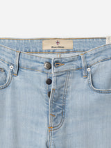 BGvinci Trueblue Jeans by Blue de Gênes feature a light wash, regular fit stretch denim, visible front buttons, belt loops, and classic five-pocket styling. The waistband has a stitched Blue de Gênes label with a red and white cross logo above.