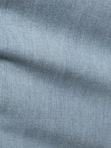 Close-up of BGvinci Trueblue Jeans - Mid Blue Denim by Blue de Gênes, revealing light blue stretch denim with a diagonal seam and detailed weave. The soft, flexible fabric has slight wrinkles, typical of regular fit jeans.