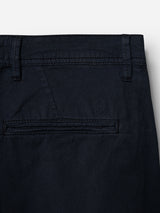 Close-up of the back pocket on BGmenzo Vecchio Chino - Dark Navy by Blue de Gênes, showing comfort stretch fabric, belt loops, a single welt pocket, and a small embroidered shield logo above the pocket.