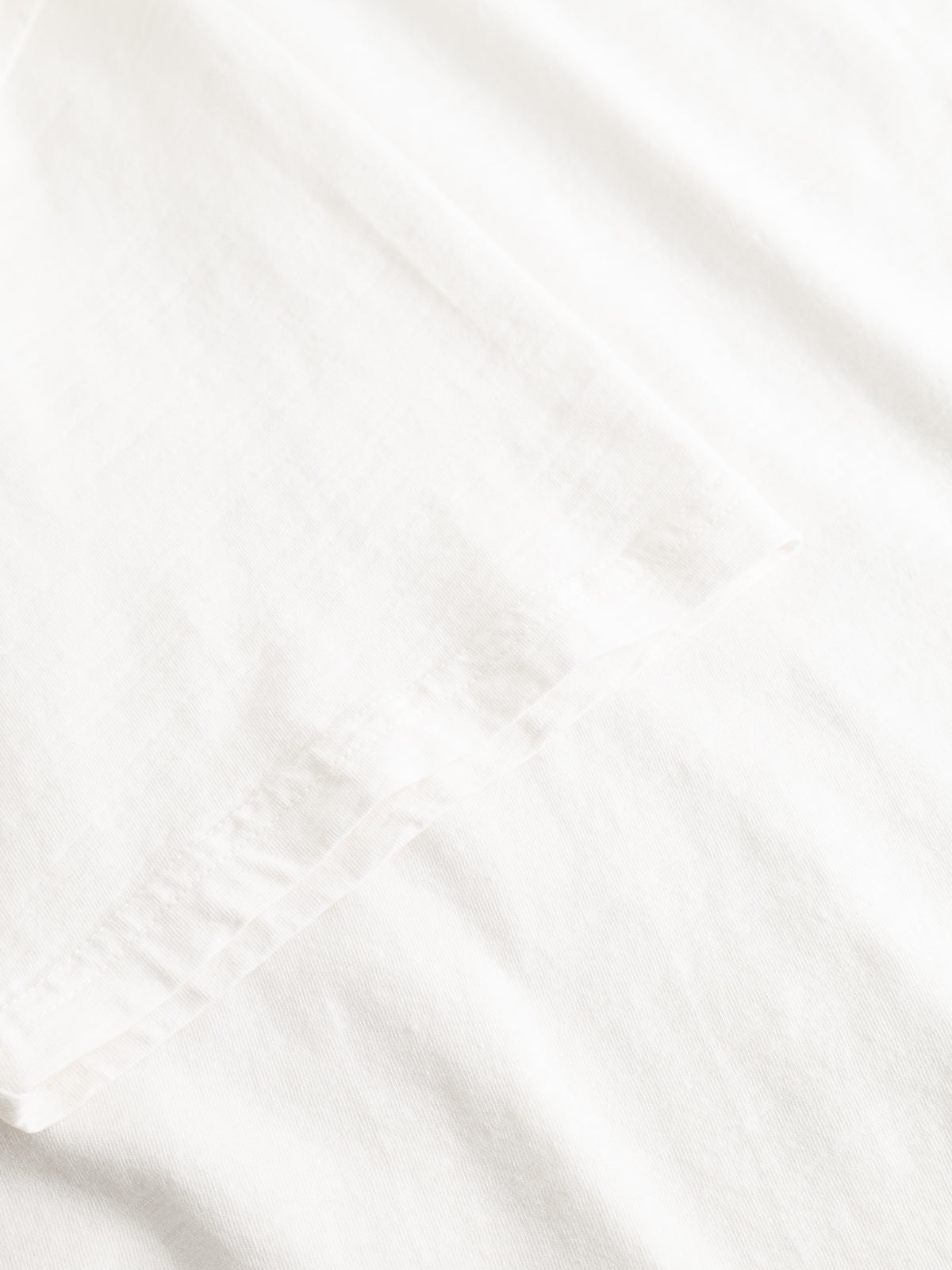 Close-up of the BGoscar T-Shirt - Snow Fall by Blue de Gênes, highlighting its smooth slub cotton texture and subtle folds—soft, lightweight, and ideal for a classic crewneck look.