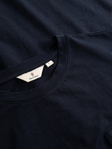 Two neatly folded dark navy BGoscar T-Shirts by Blue de Gênes are shown, with one highlighting a visible crewneck collar and label. Made from 100% cotton for exceptional softness and comfort.