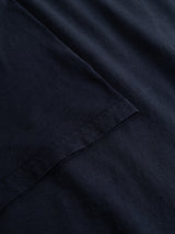 Close-up of the BGoscar T-Shirt in Dark Navy by Blue de Gênes, showing the neatly stitched sleeve hem over the body and highlighting the soft slub cotton texture.