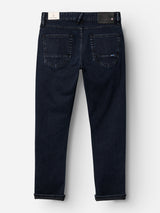 The BGvinci Black OD Jeans by Blue de Gênes, in blue black stretch denim, are shown from the back with two rear pockets, rolled cuffs, and black and white brand labels on the waistband.