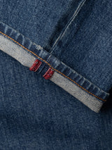 Close-up of BGvinci Break Jeans in Denim wash by Blue de Gênes, featuring a cuffed hem that showcases the selvedge edge and distinctive red stitching. Crafted from comfort stretch denim, the texture and weave of the fabric are clearly visible.