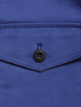 Close-up of the BGcanopy Jacket - Navy Peony by Blue de Gênes, featuring a workwear-style pocket with a flap and black button. The visible stitching along the edges of the pocket and buttonhole highlights the fine details and textured heavy cotton fabric.