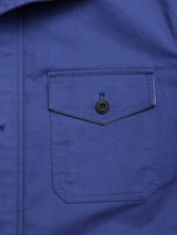Close-up of the Blue de Gênes BGcanopy Jacket in Navy Peony, featuring a buttoned chest pocket, visible stitching, and a vertical seam detail along the left side.