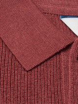 Close-up of the Porto Polo Knit - Henna by Blue de Gênes, showing its ribbed, reddish-brown luxury fabric, folded collar, and a glimpse of the blue and white label in the top right corner.