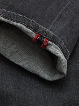 Close-up of the cuff on Blue de Gênes Vinci G Dark Grey Jeans in grey denim, highlighting the inside seam with red stitching detail and visible selvedge edge, expertly crafted in Italy from comfort stretch denim.