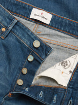Close-up of the Vinci Topaz Vintage Jeans - Used by Blue de Gênes, featuring blue denim in a regular fit with exposed brass buttons, orange stitching, and a visible white inner label marked “Blue de Gênes.” Made in Italy from comfort stretch denim, these jeans showcase patterned pocket lining.